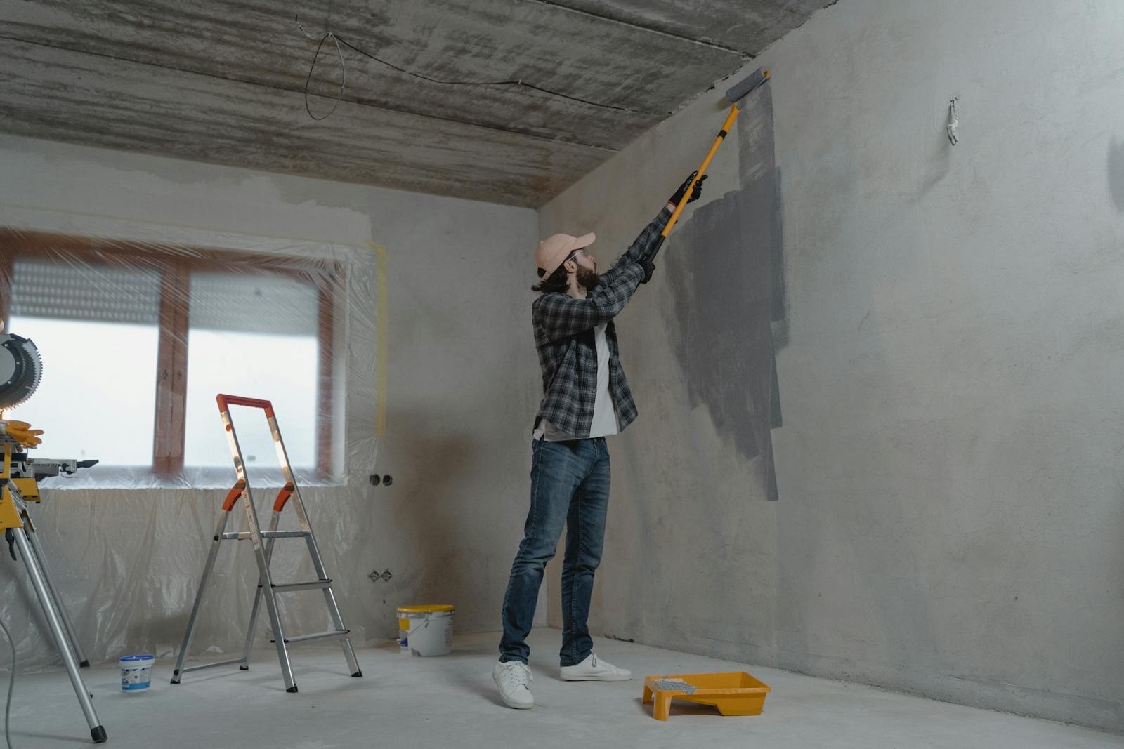 Painter using a roller on a commercial interior wall