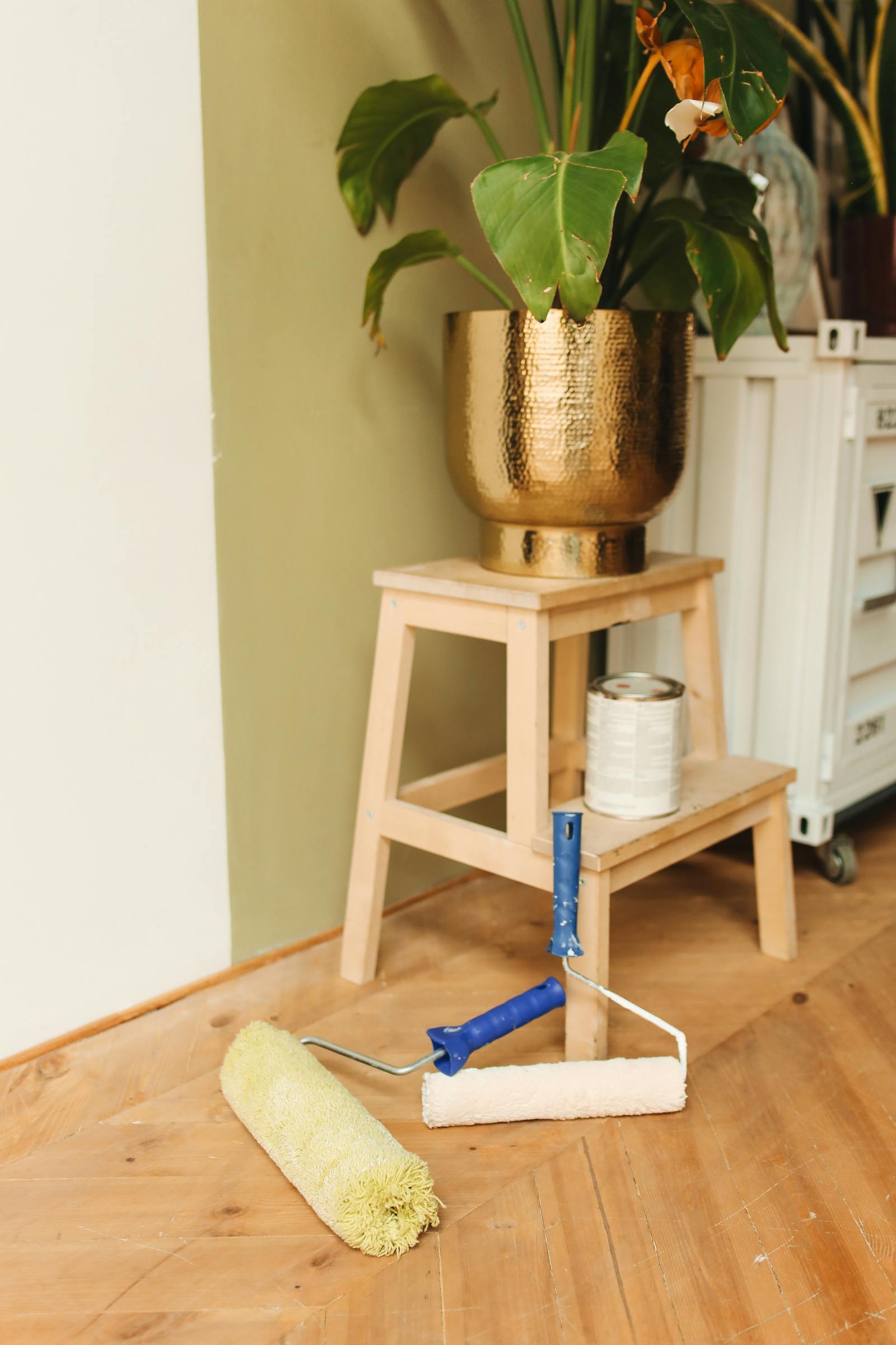 Paint rollers and decorating tools in a refreshed living room